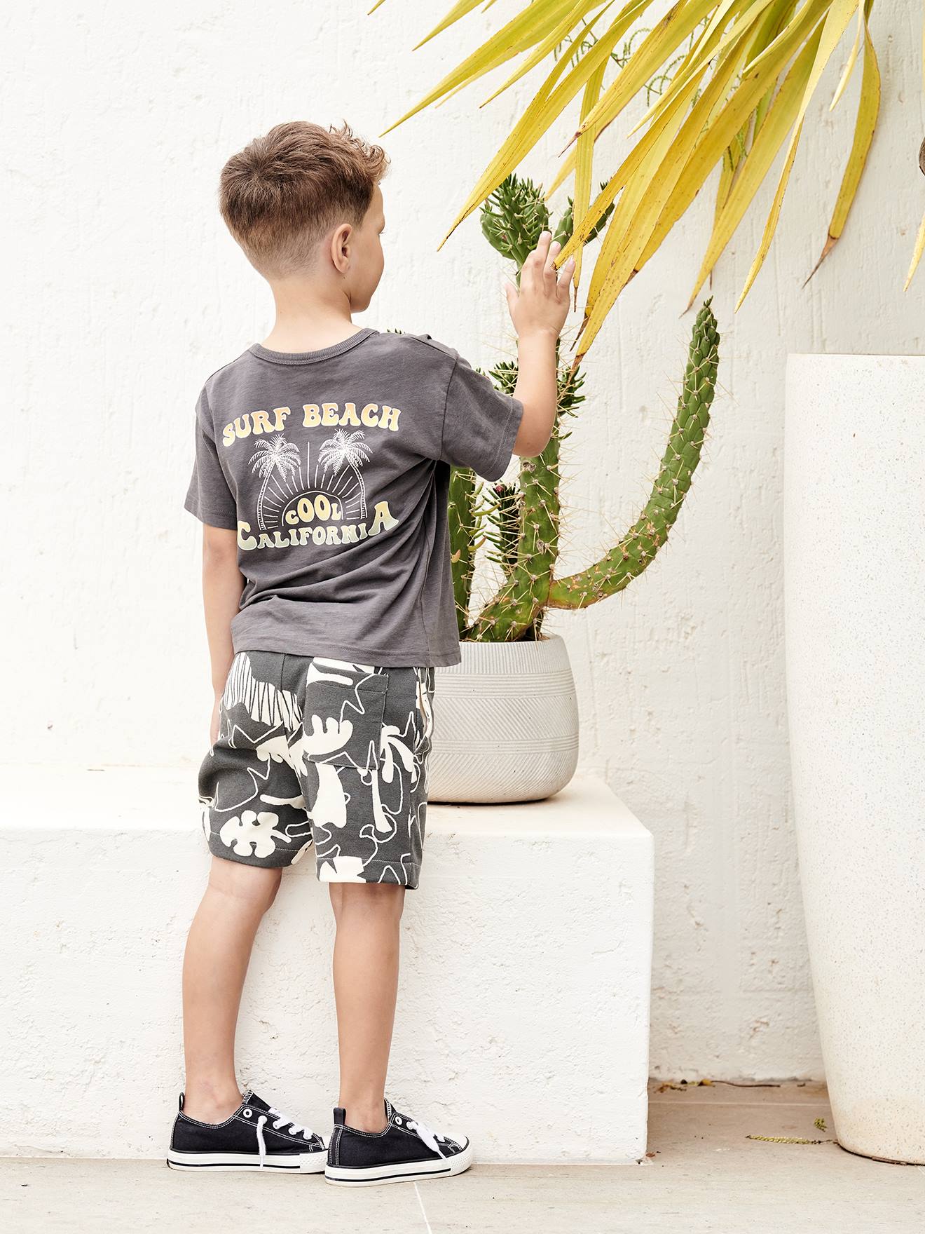 Camiseta infantil cinza com estampa gigante nas costas.