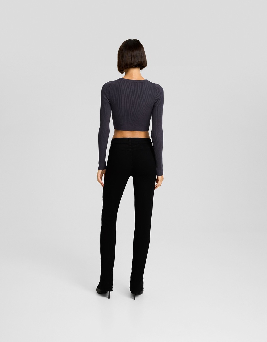 Calça jeans skinny de cintura baixa com fenda frontal