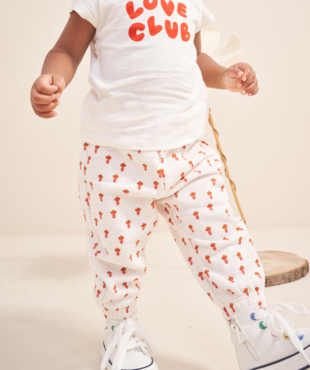 JOGGING BÉBÉ FILLE EN FIBRES RECYCLÉES ÉCRU CHINÉ IMPRIMÉ FLEURI ORANGE