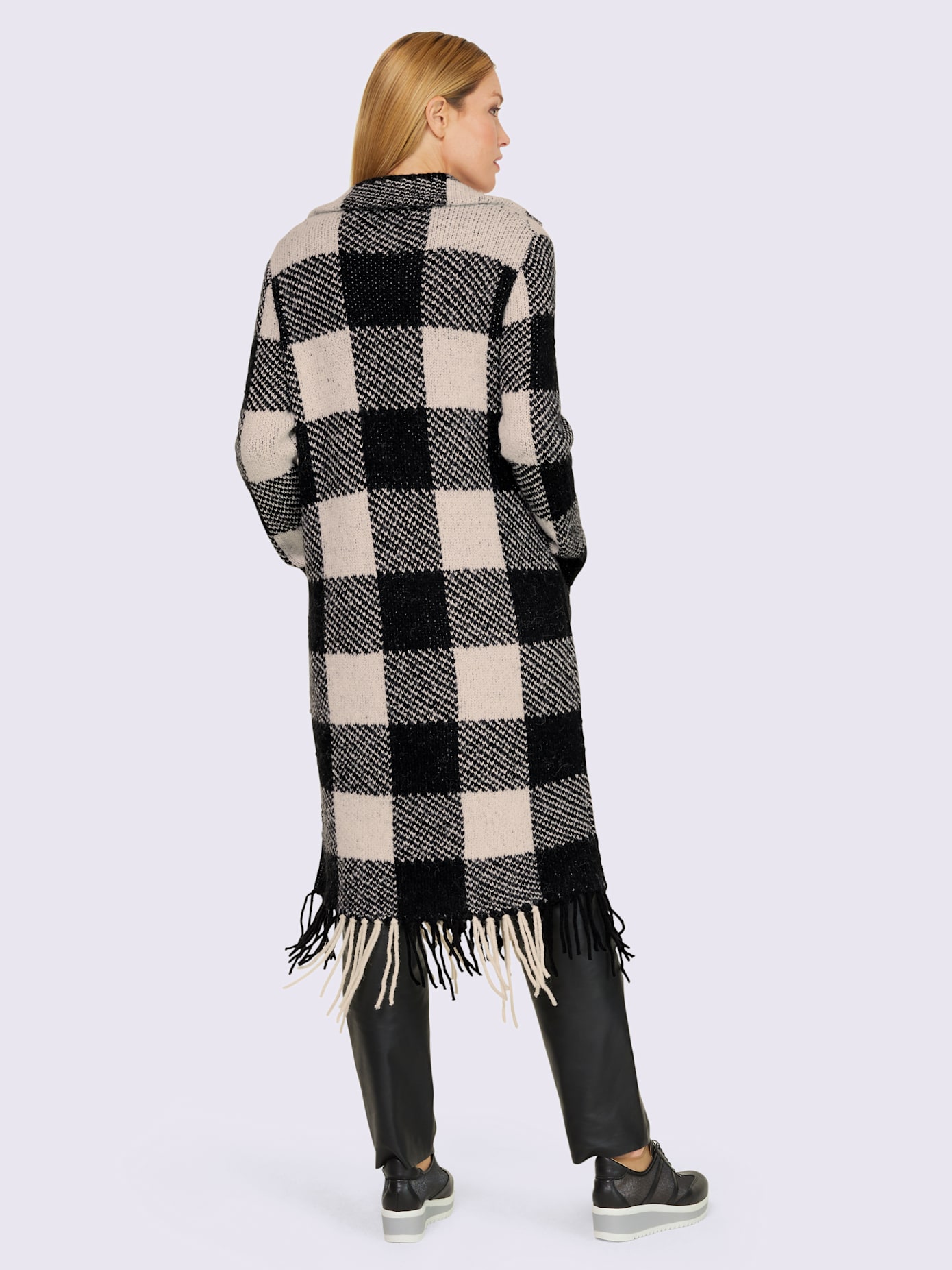 Manteau en tricot finitions arrondies à franges