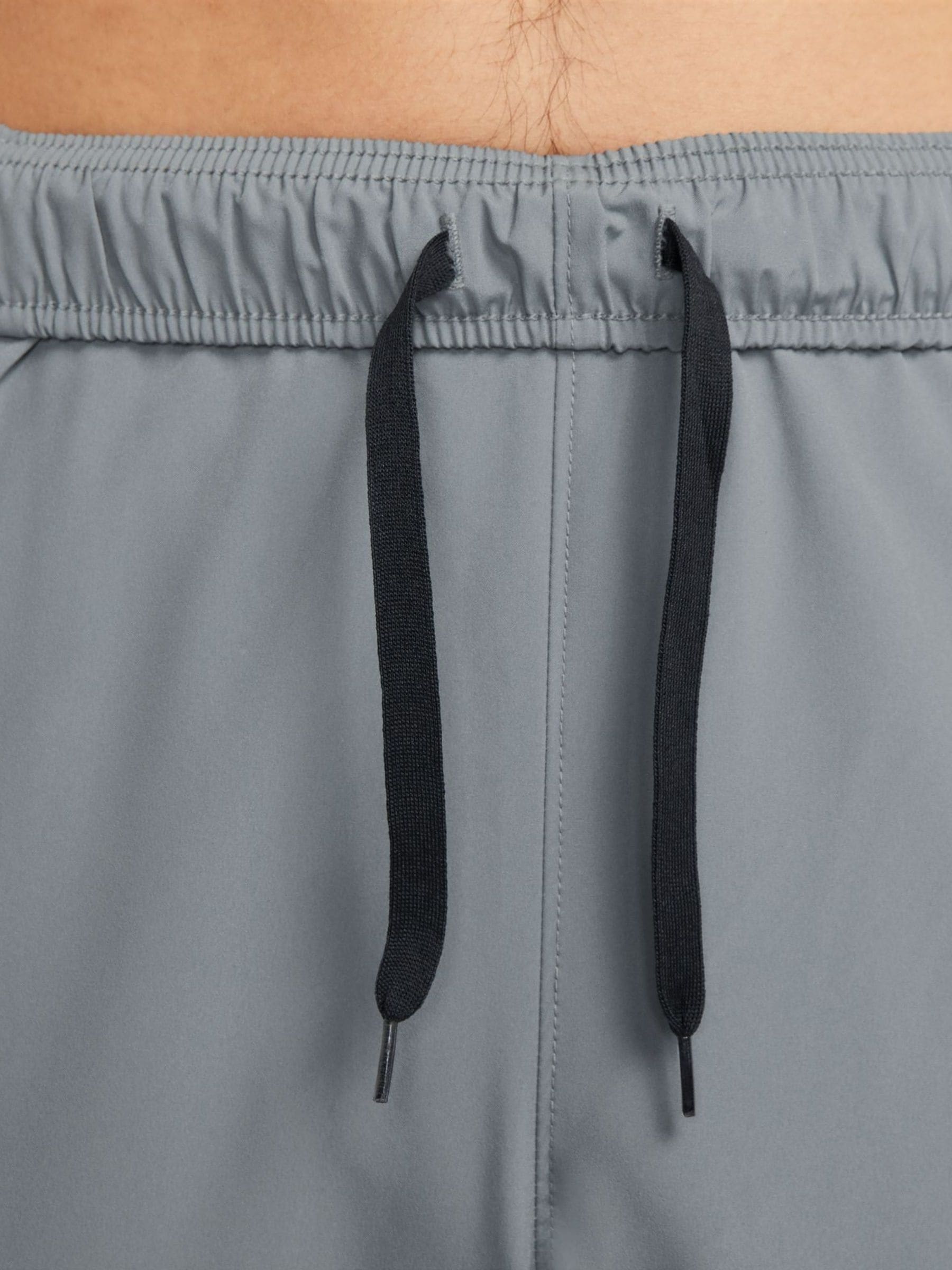 Rookgrijs - Nike Dri-FIT Form trainingsbroek met taps toelopende pijpen