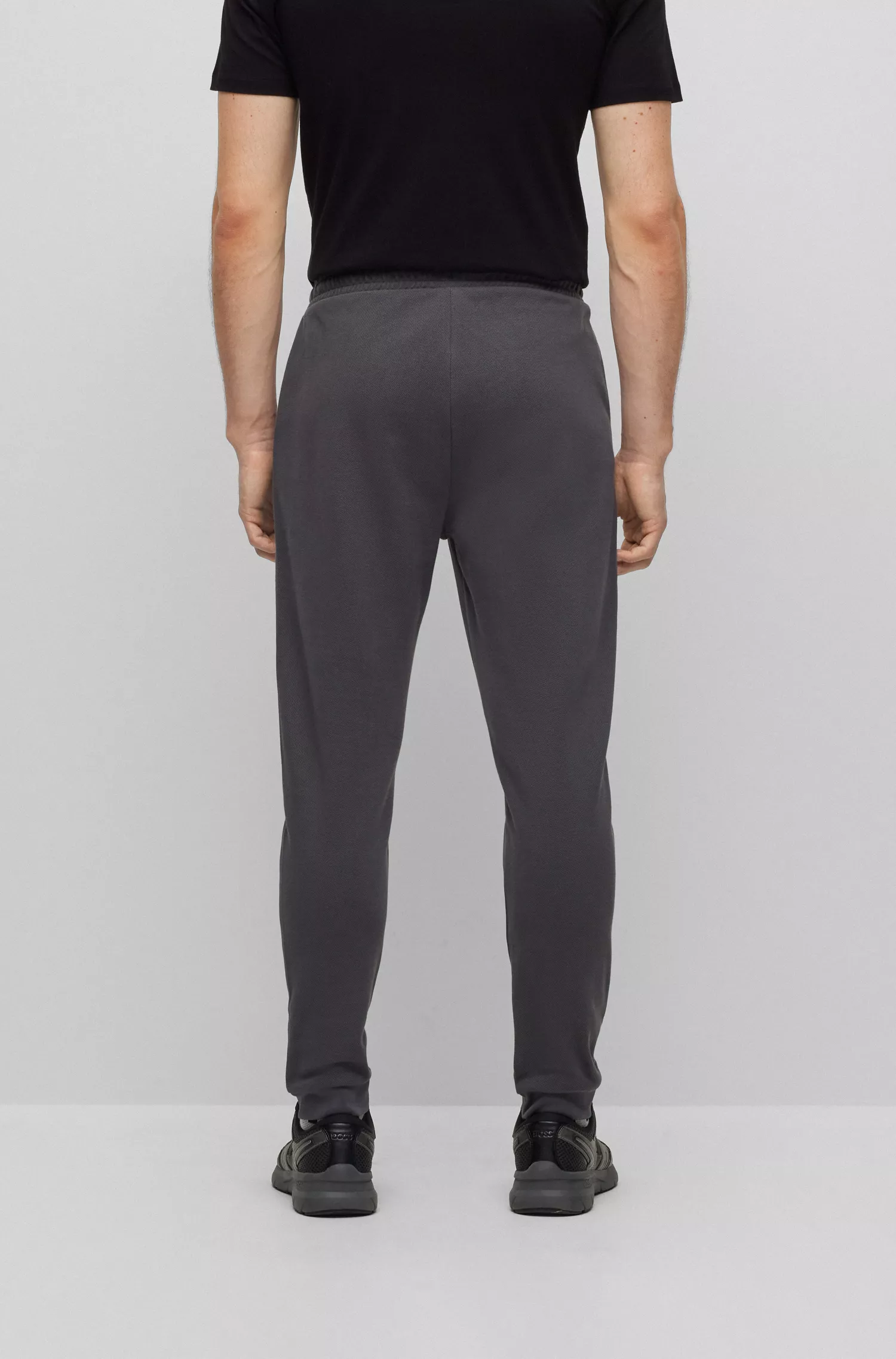 Calça de fato de treino BOSS verde em algodão interlock com logótipo curvo