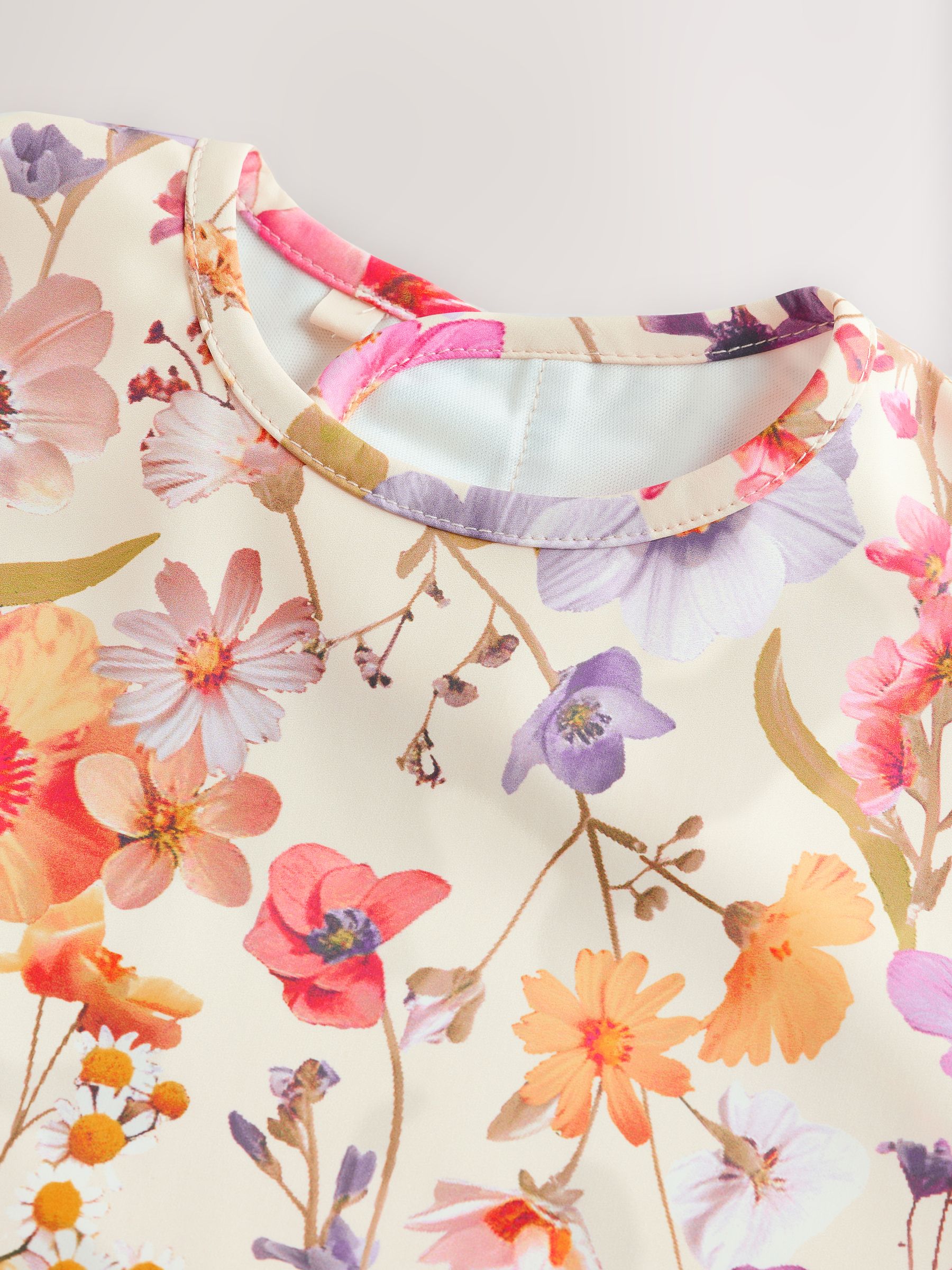 Natuurlijk kalm Bloemen - Slabbetje met mouwen voor spenen en voeden