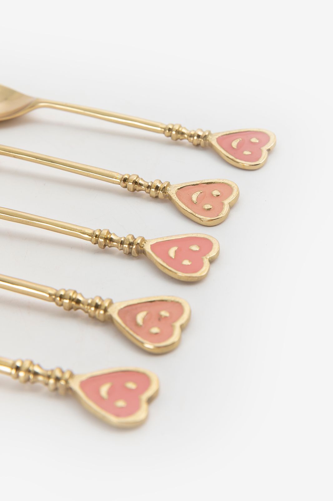 Roze en goudkleurige theelepels smiley hartjes