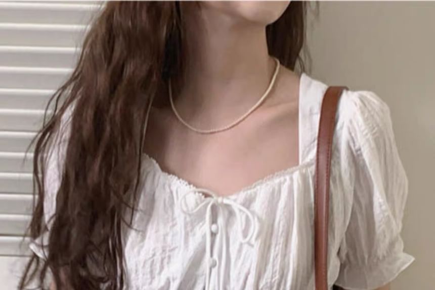 minaga - Effen blouse met kanten rand en pofmouwen