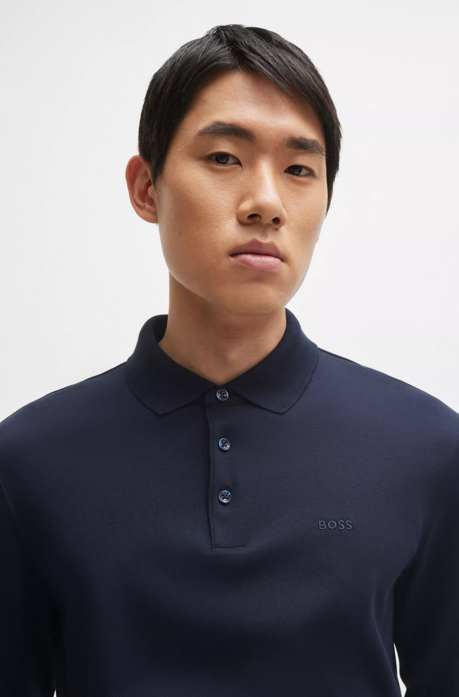 Camisa polo BOSS preta em algodão interlock com logotipo bordado.